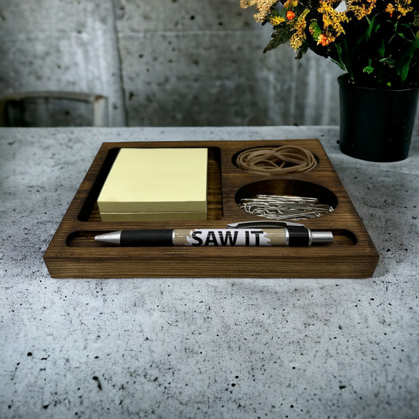 Wooden office desk tidy with pen, sticky notes, paperclips