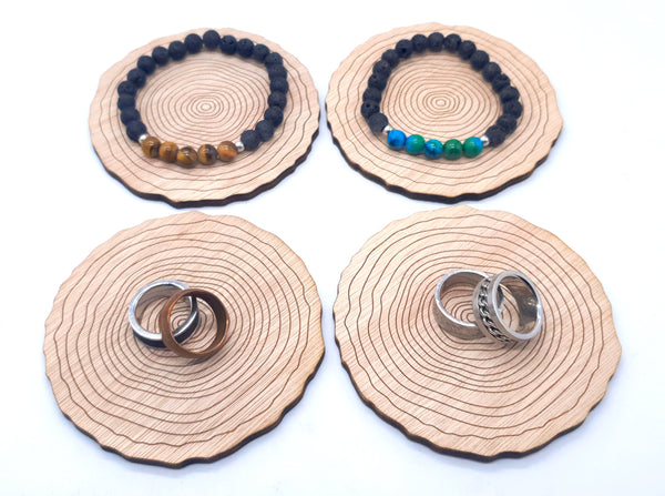 4 plywood log slices with bracelets on 