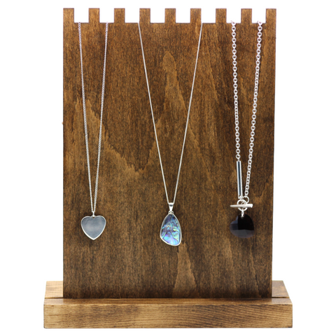Grooved plywood display with necklaces on 
