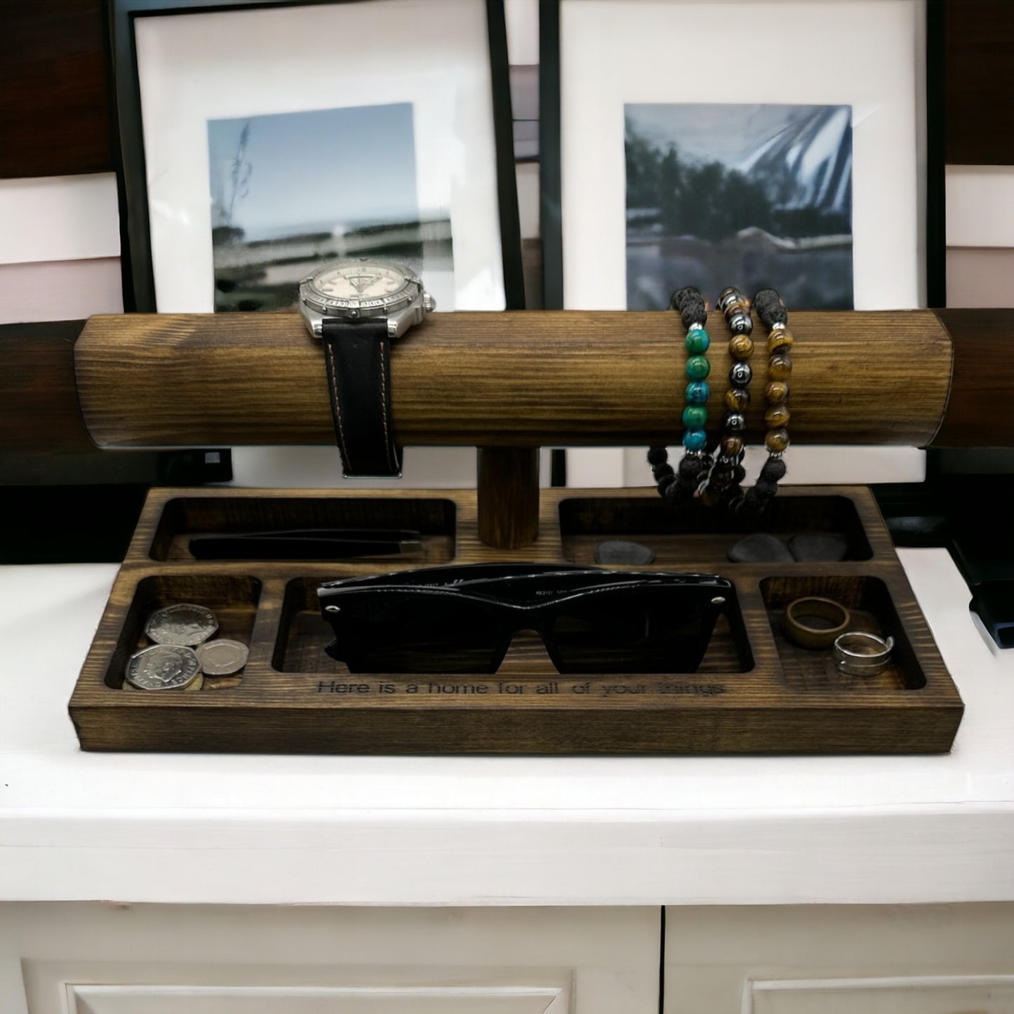 Wooden watch and bracelet display with jewellery on.