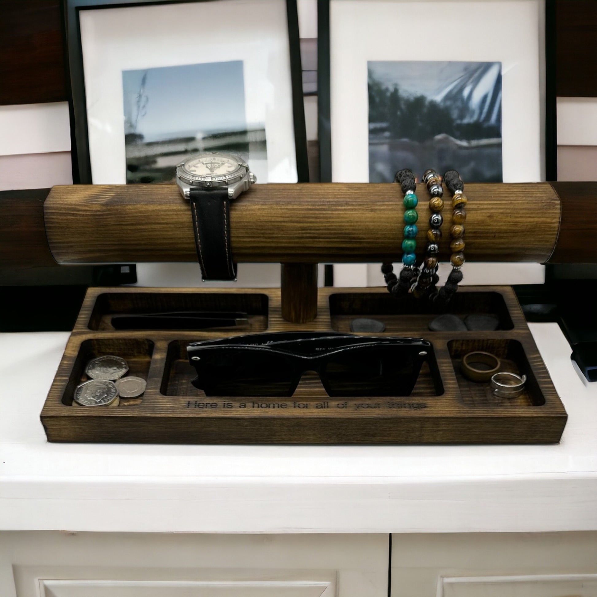 Wooden watch and bracelet display with jewellery on.