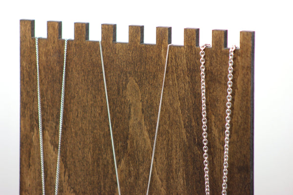 close up plywood necklace display